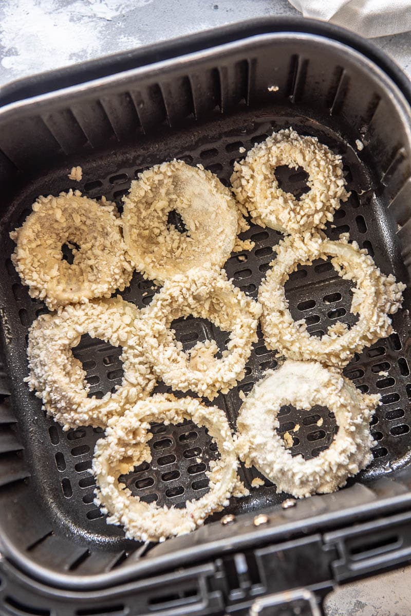 onion rings in an air fryer basket
