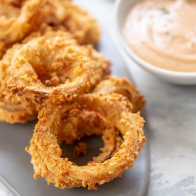 fried onion rings with a bowl of yum yum sauce