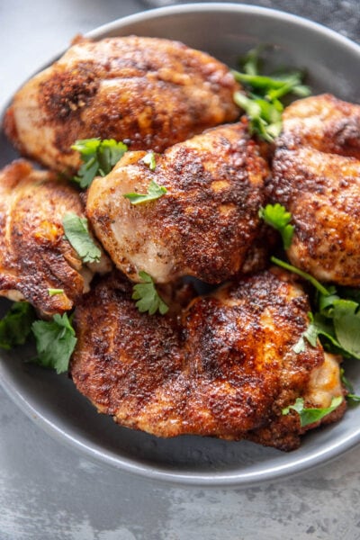 chicken thighs on a plate with garnish