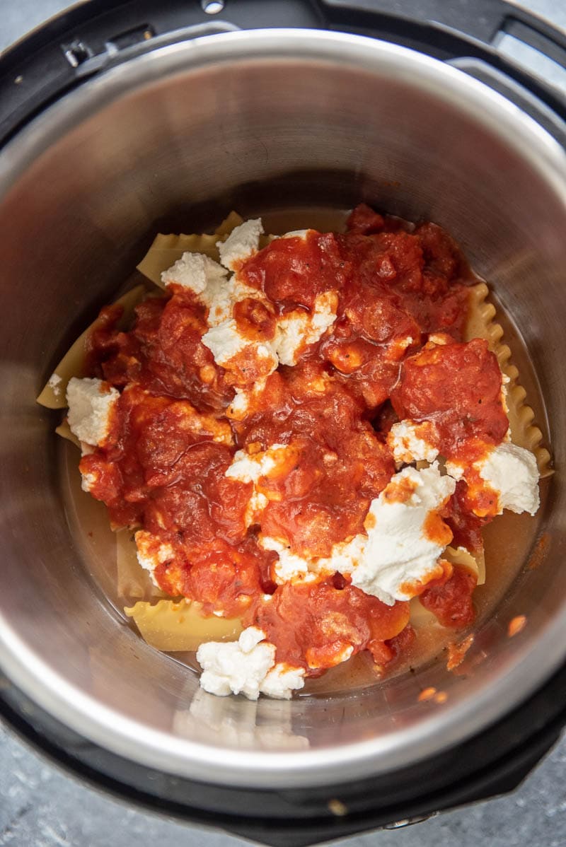 dry lasagna noodles, sauce and ricotta cheese in instant pot