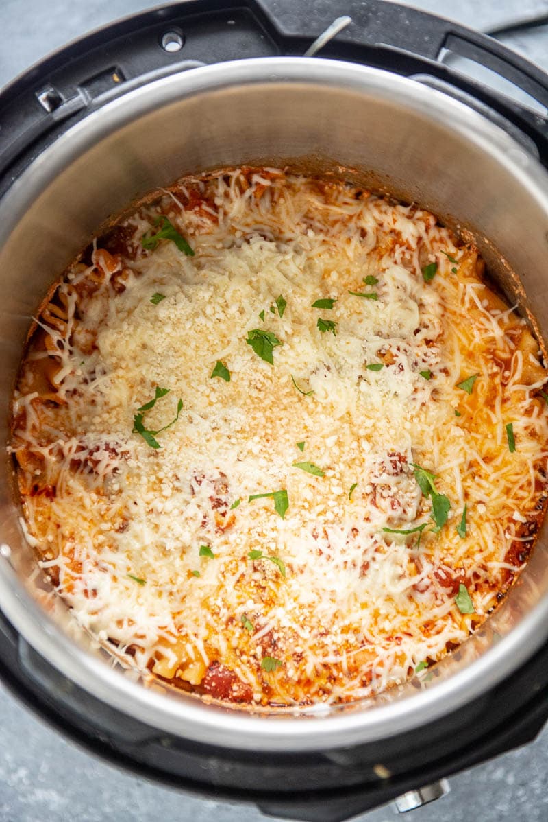 instant pot with cooked cheese lasagna topped with parmesan and parsely