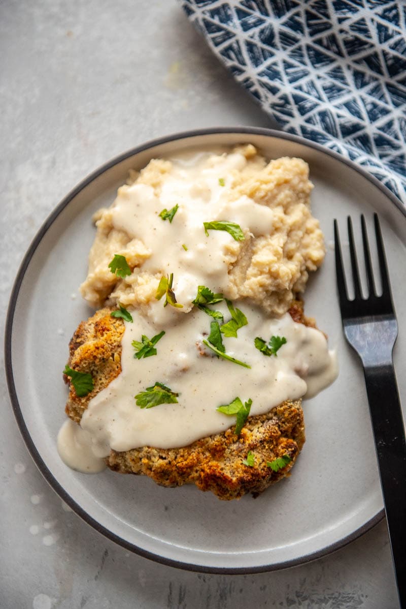 chicken fried steak on a plate with fork