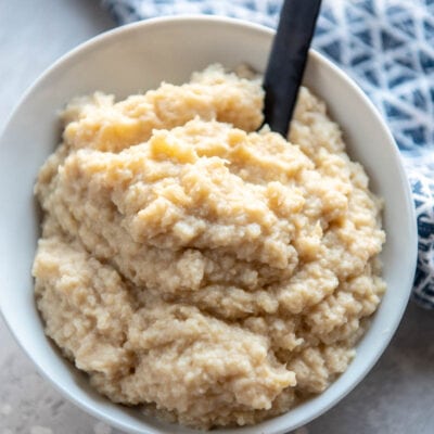 mashed cauliflower in a bowl with spoon