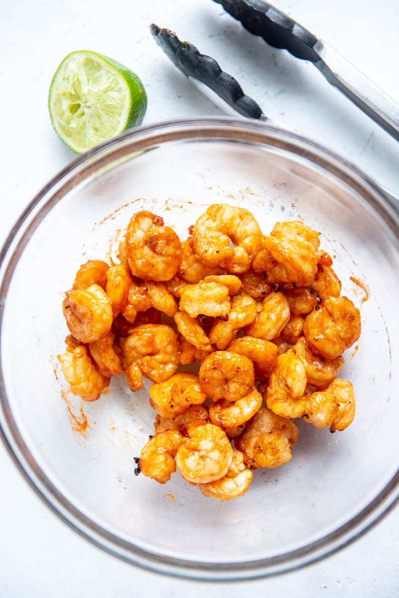 sriracha shrimp on a plate with garnish