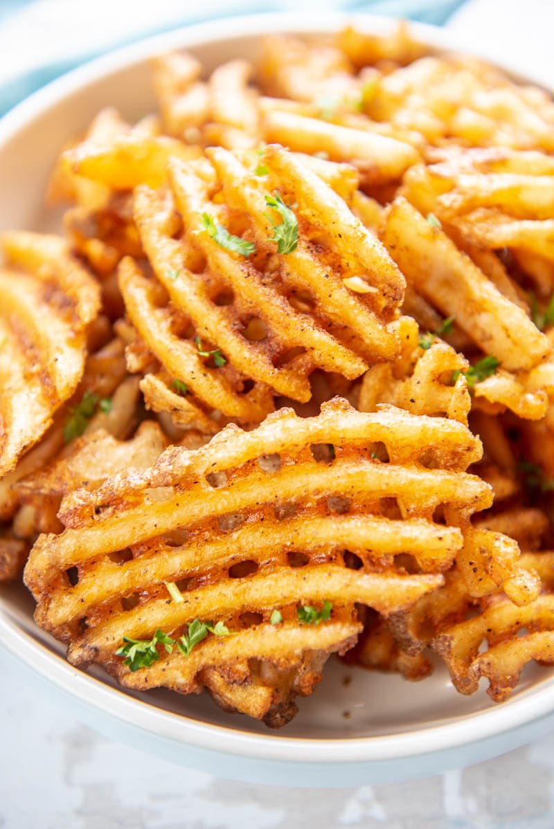 closeup of waffle fries in a bowl