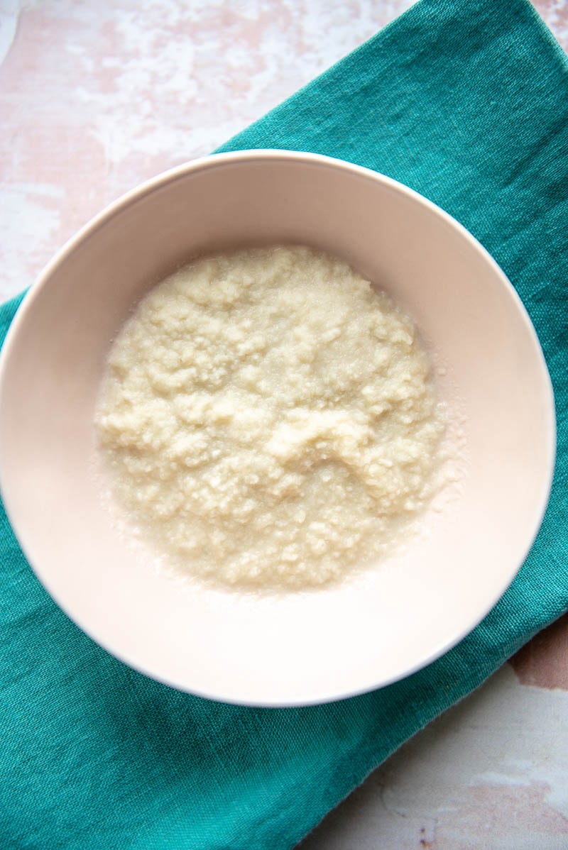 small bowl with soaked panko breadcrumbs