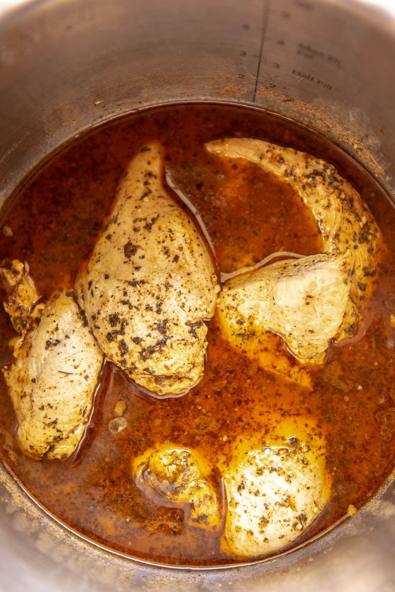 cooked chicken and spices in an instant pot