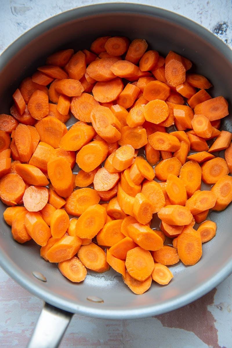 sliced carrots in grey skillet