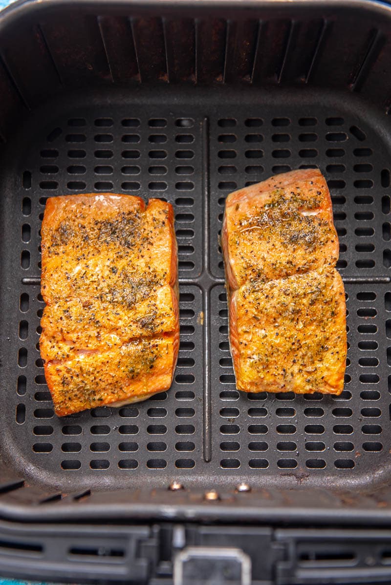 cooked seasoned salmon in air fryer basket