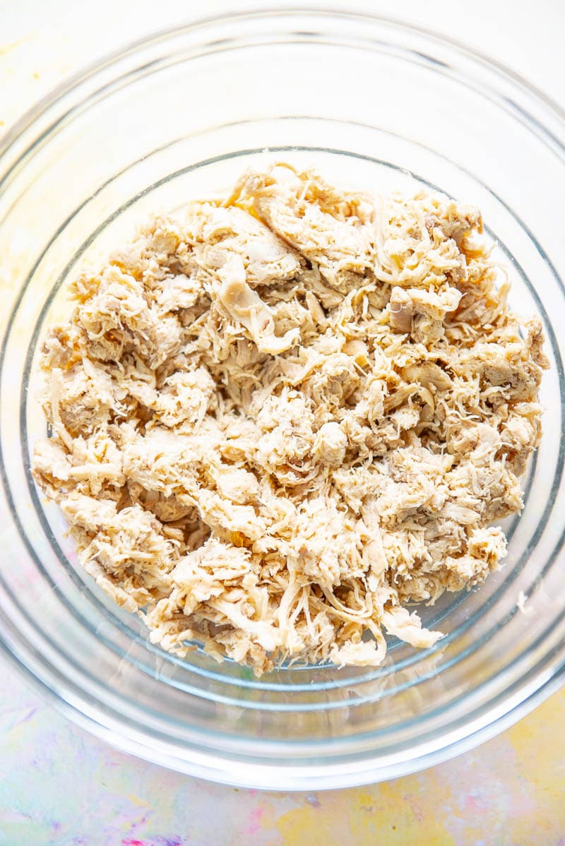glass bowl filled with shredded chicken