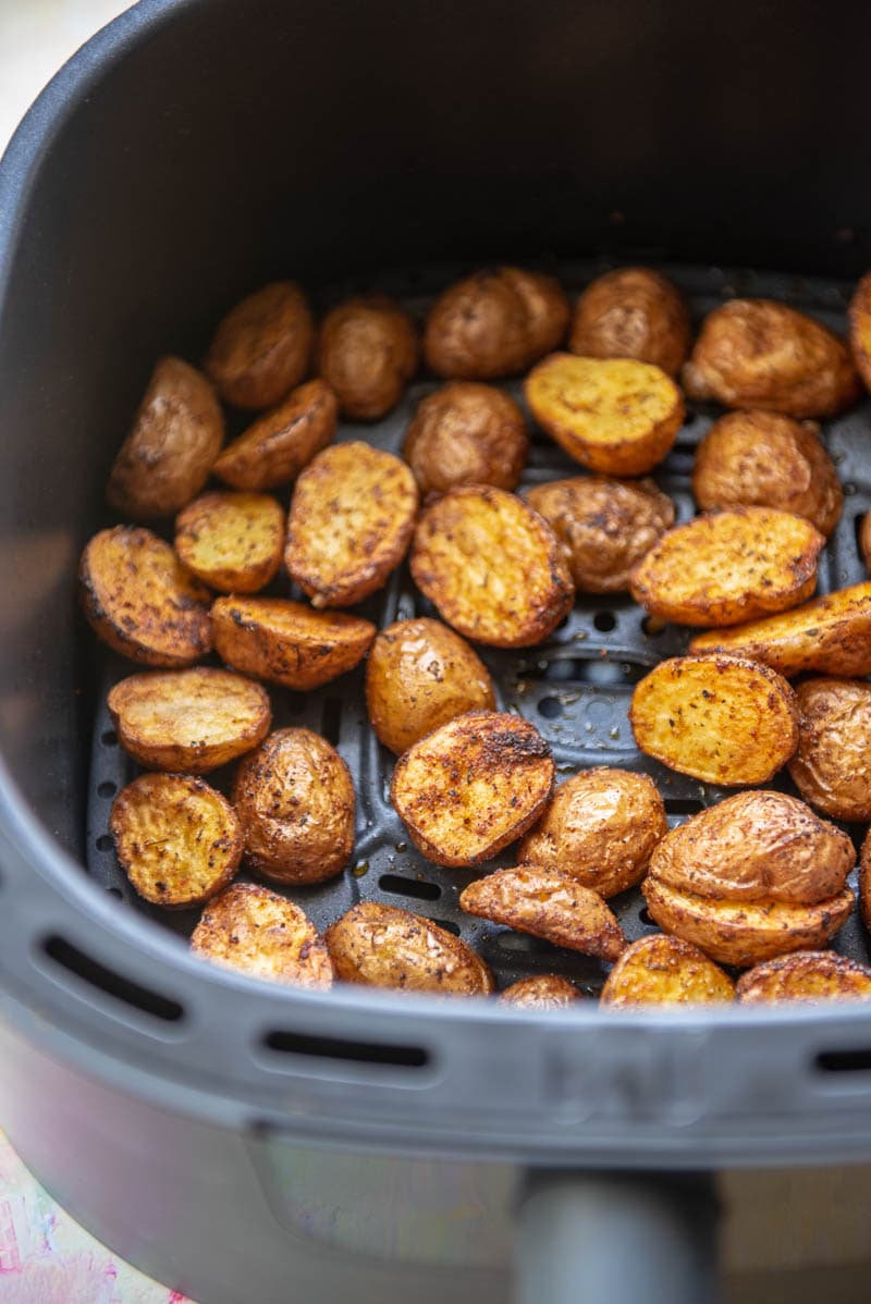 air fryer basket with seasoned baby potatoes