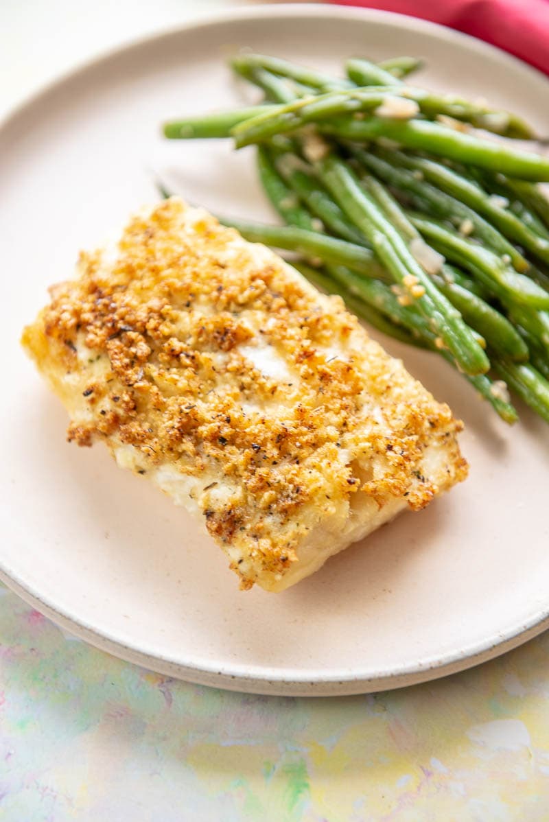 air fryer cod and green beans on pink plate