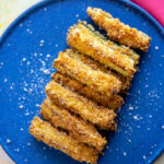 overhead of zucchini fries from the air fryer on a blue plate