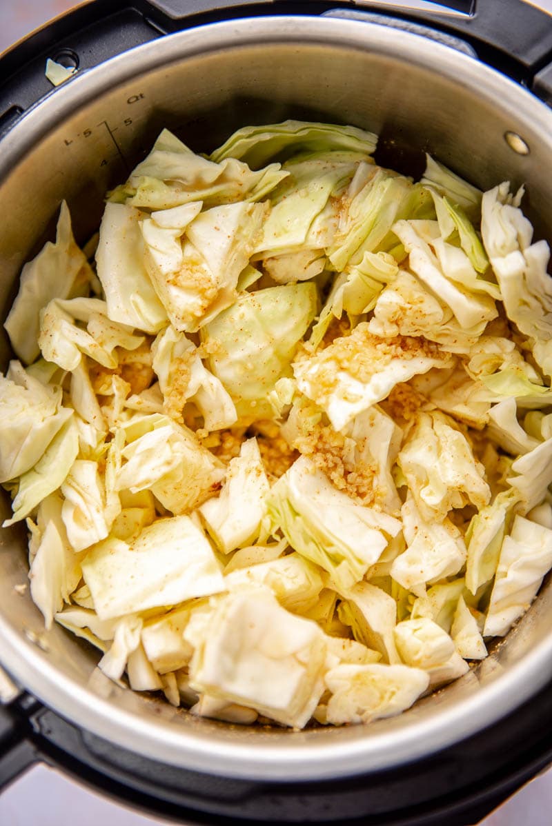 instant pot filled with raw chopped cabbage ready to cook