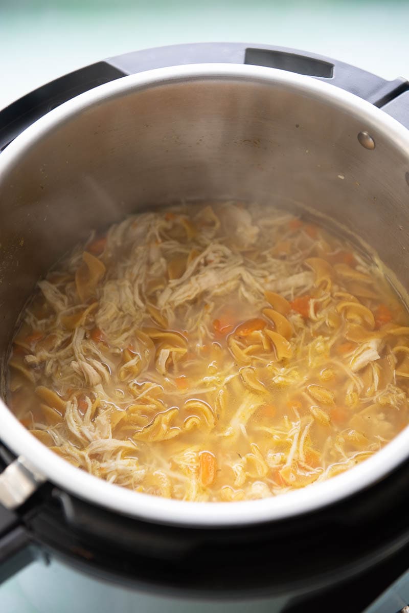 instant pot with steaming chicken noodle soup