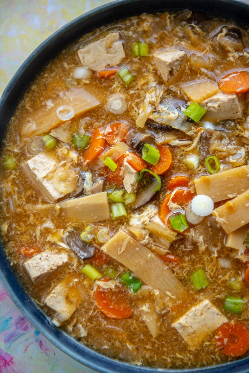 close of of hot and sour soup in a blue bowl