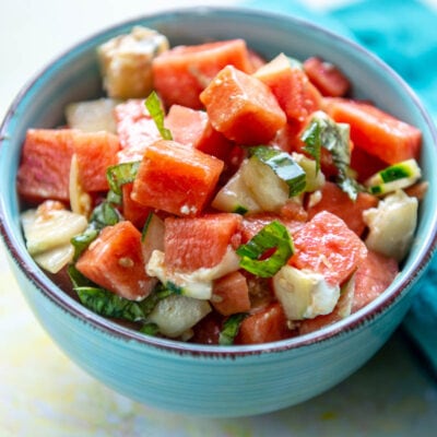 blue bowl filled with watermelon and basil salad