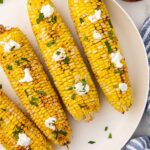 air fryer corn on the cob served and garnished on plate