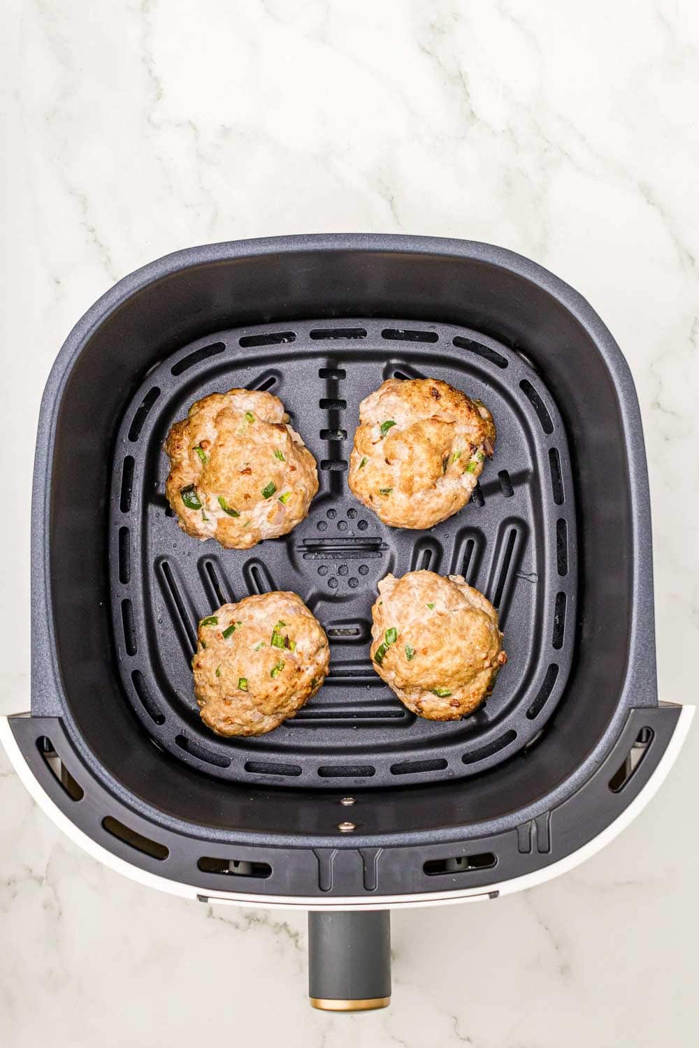 "Cooked turkey patties mixed with red onions and jalapenos in air fryer