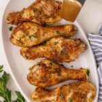 Air Fryer Chicken Drumsticks served on plate and garnished