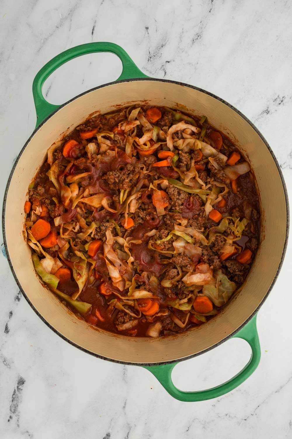 dutch oven filled with beef and cabbage casserole