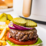 Burger served with tomato, ketchup, red onion, lettuce and no top bun