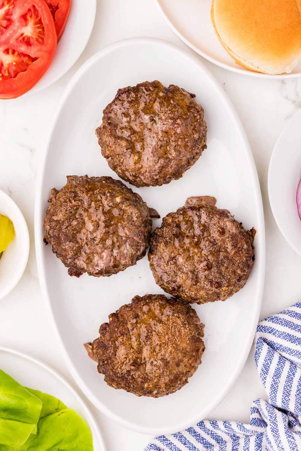 4 cooked patties on late plate