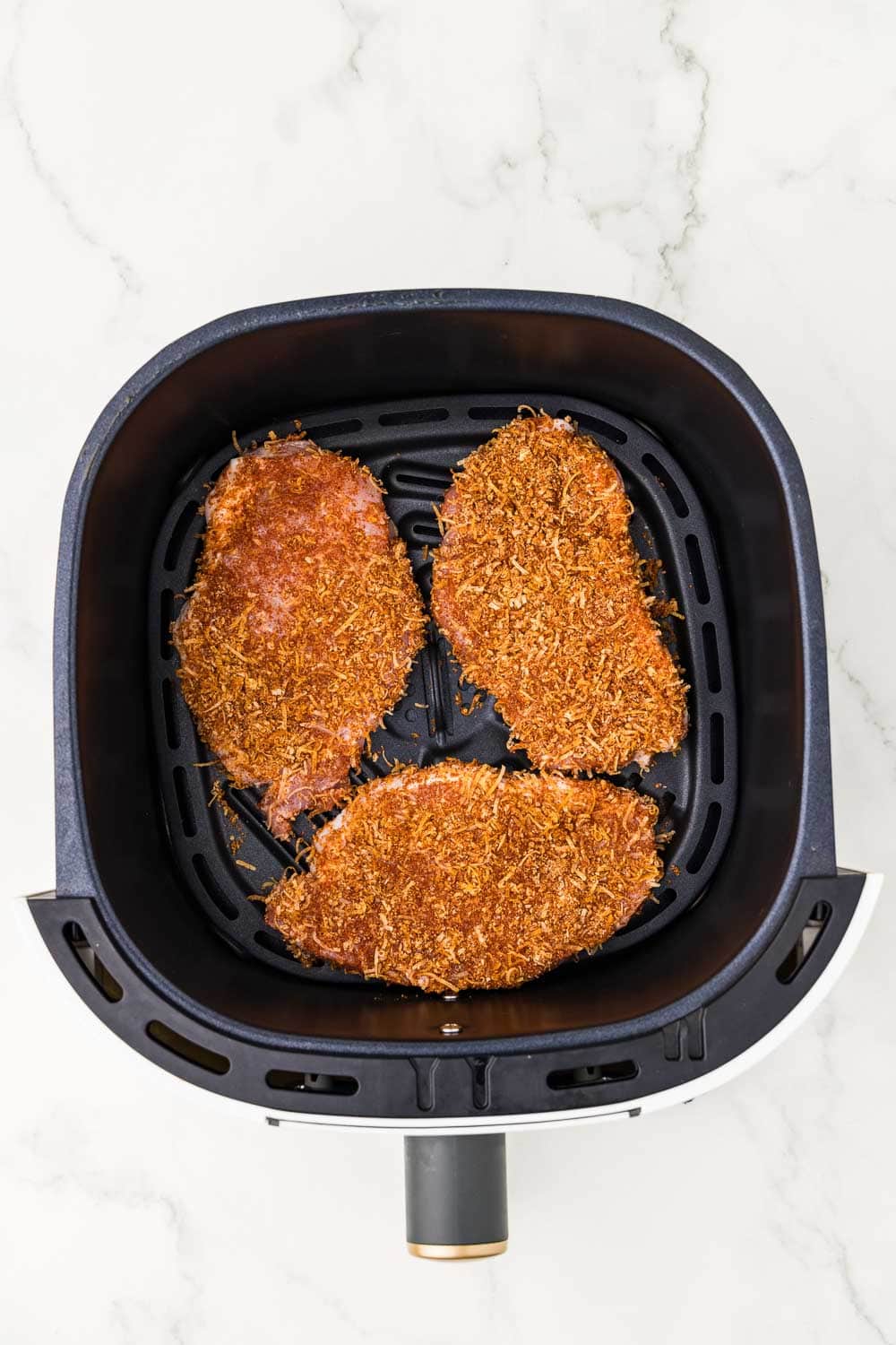 4 unCooked Boneless Pork Chops in air fryer