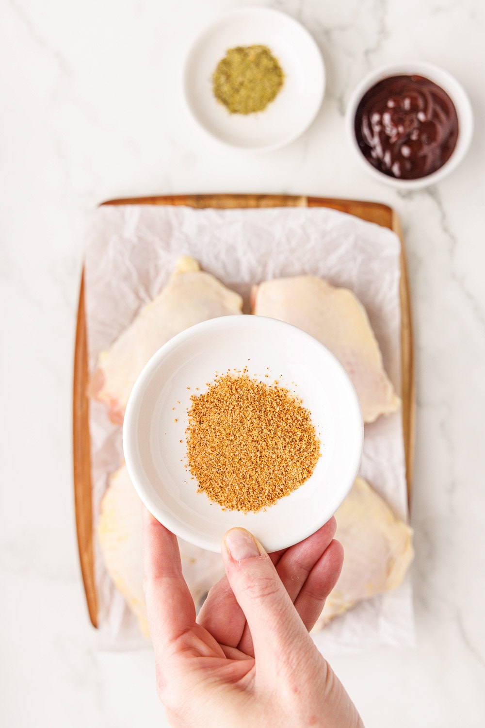 Seasoning for BBQ chicken recipe above raw chicken thighs