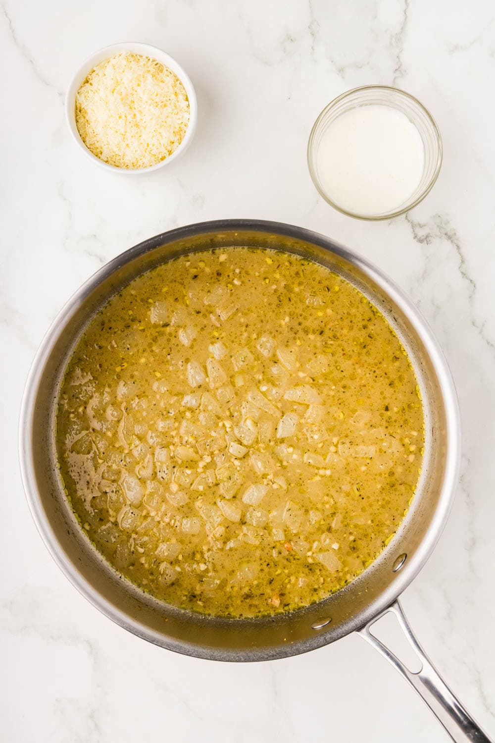 Lemon juice and chicken broth in a pan being brought to a a simmer for around 5 minutes