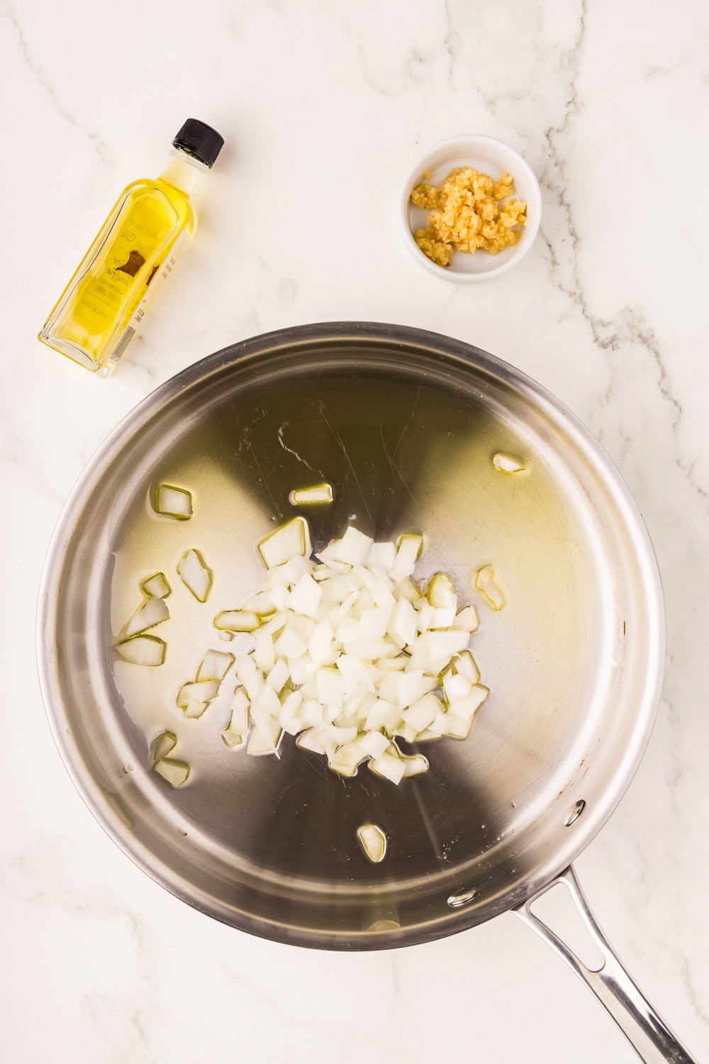 In a 12 inch skillet heat olive oil and onion and garlic and saute for 3-4 minutes until onion starts to soften