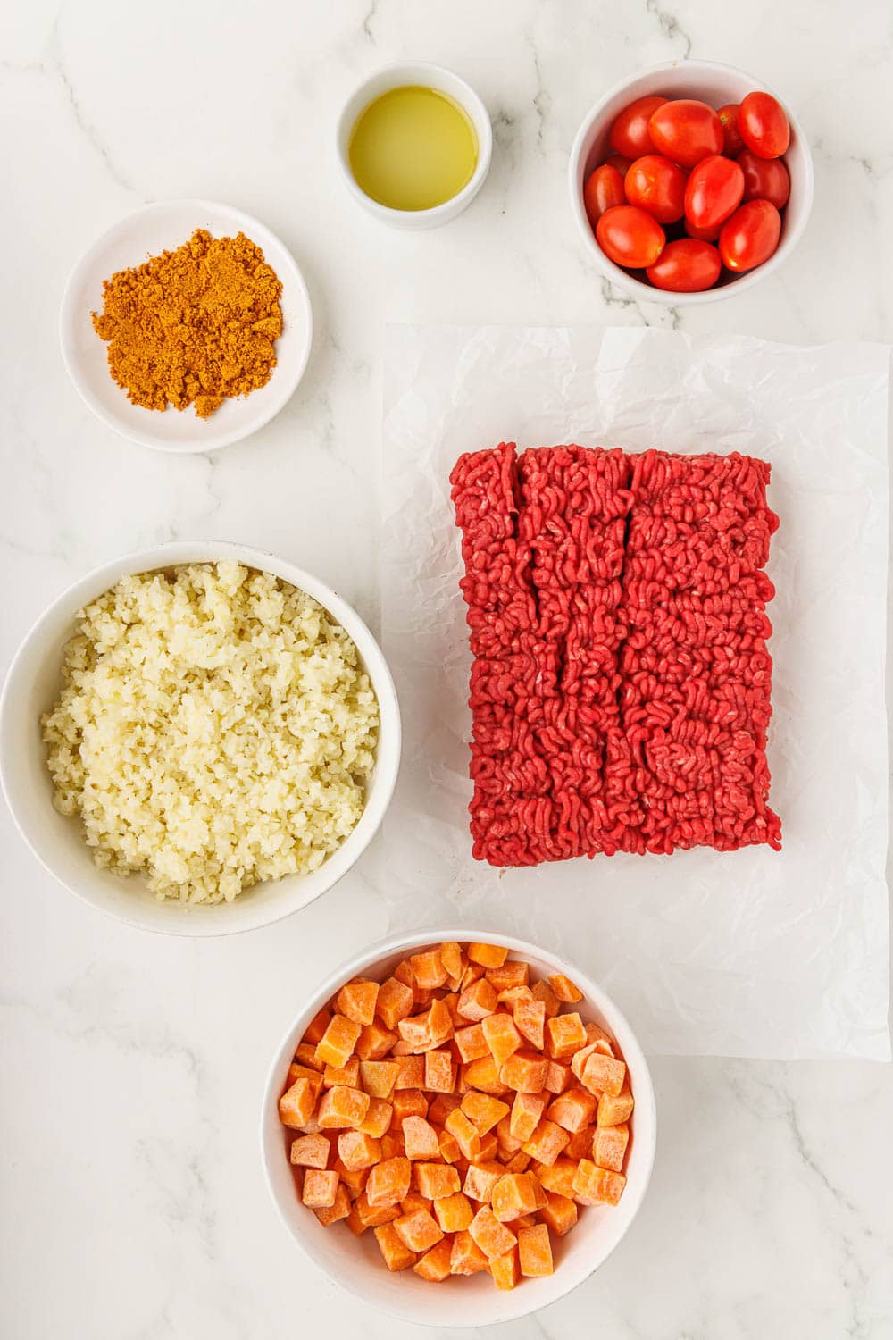 1 pound lean ground beef
2 tablespoons homemade taco seasoning
2 tablespoons water
12 oz frozen cauliflower rice
1 tablespoon avocado oil
12 oz frozen cubed sweet potatoes
1 cup grape tomatoes
