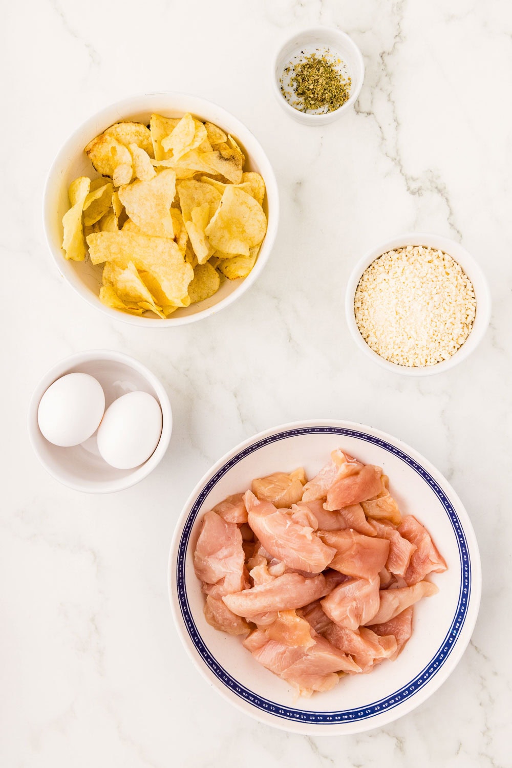 1 pound boneless skinless chicken breasts tenders 2 eggs 2 oz potato chips 2 oz 1 teaspoon on counter ready to make air fryer chicken nuggets