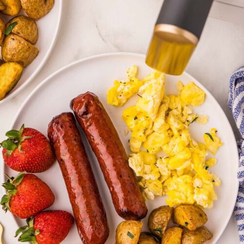 Chopped Air Fryer Chicken Sausage served on a plate with eggs, potatoes, and strawberries