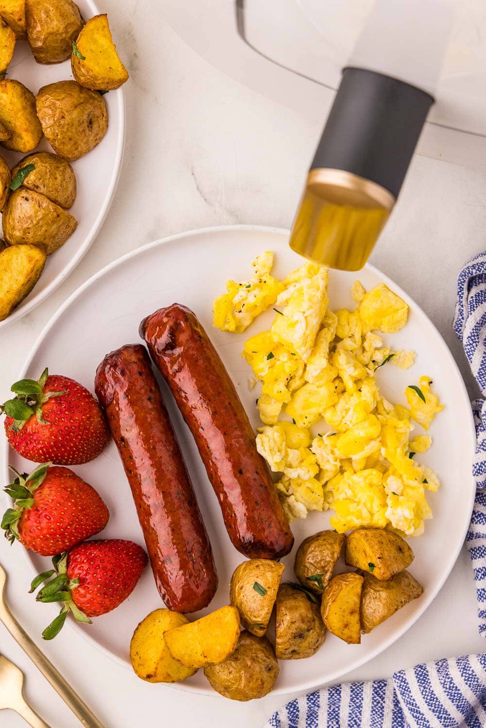 Chopped Air Fryer Chicken Sausage served on a plate with eggs, potatoes, and strawberries