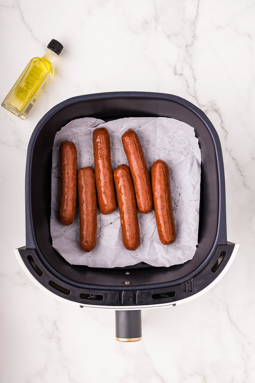 Chicken sausage on parchment paper in air fryer