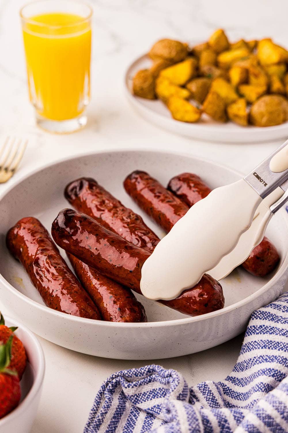 Air Fryer Chicken Sausage served and picked up with tongs