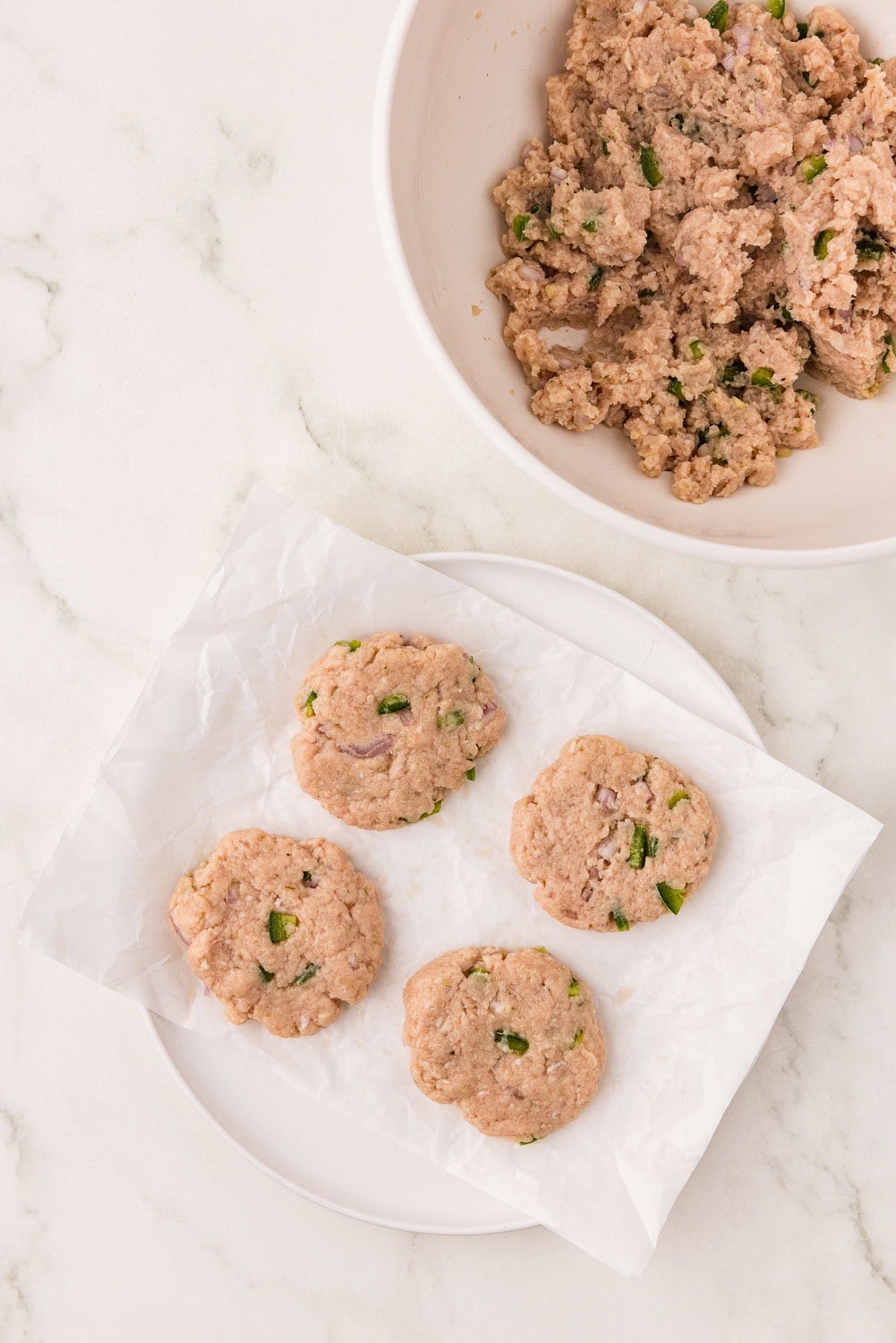 Formed sausage patties on parchment paper ready to cook