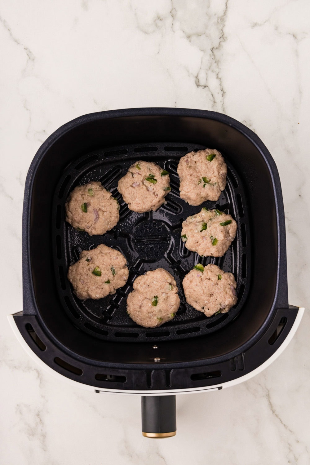 Raw Sausage Patties ready and formed in air fryer basket