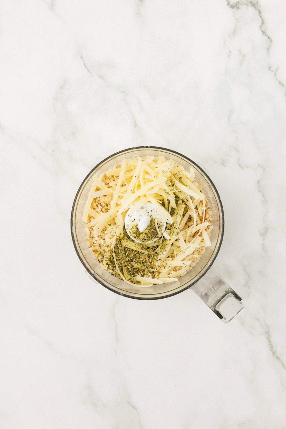 Cheese and seasonings in measuring cup