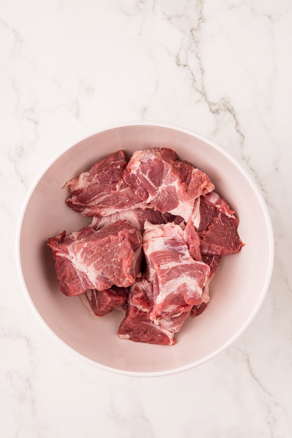 Cut pork into 4-6 chunks into bowl