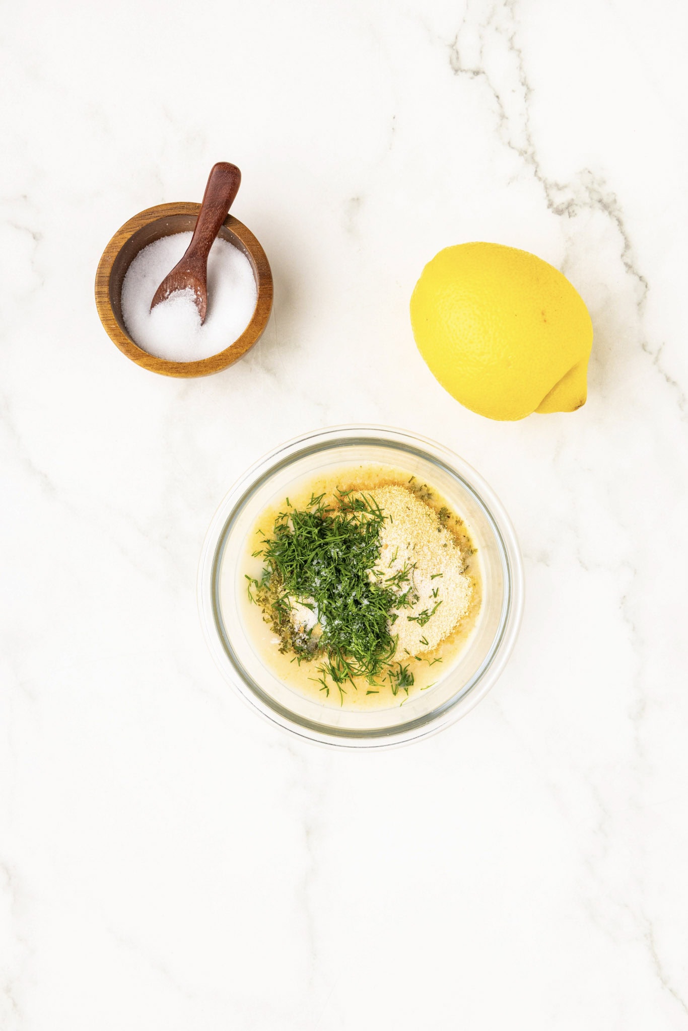 bowl of salt, a lemon and a mayo with hers mixture