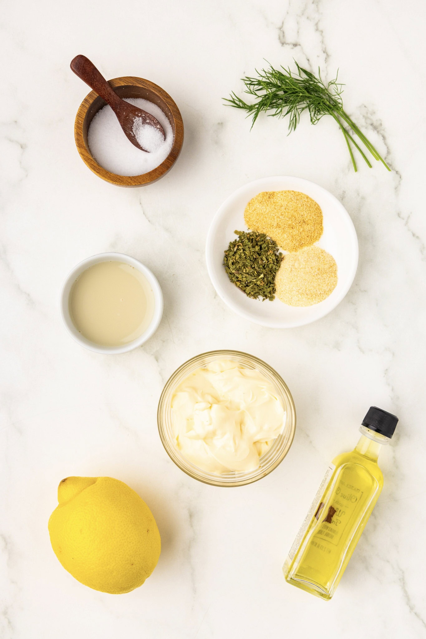 Ingredients for homemade ranch dressing including mayo, oil, lemon juice and spices