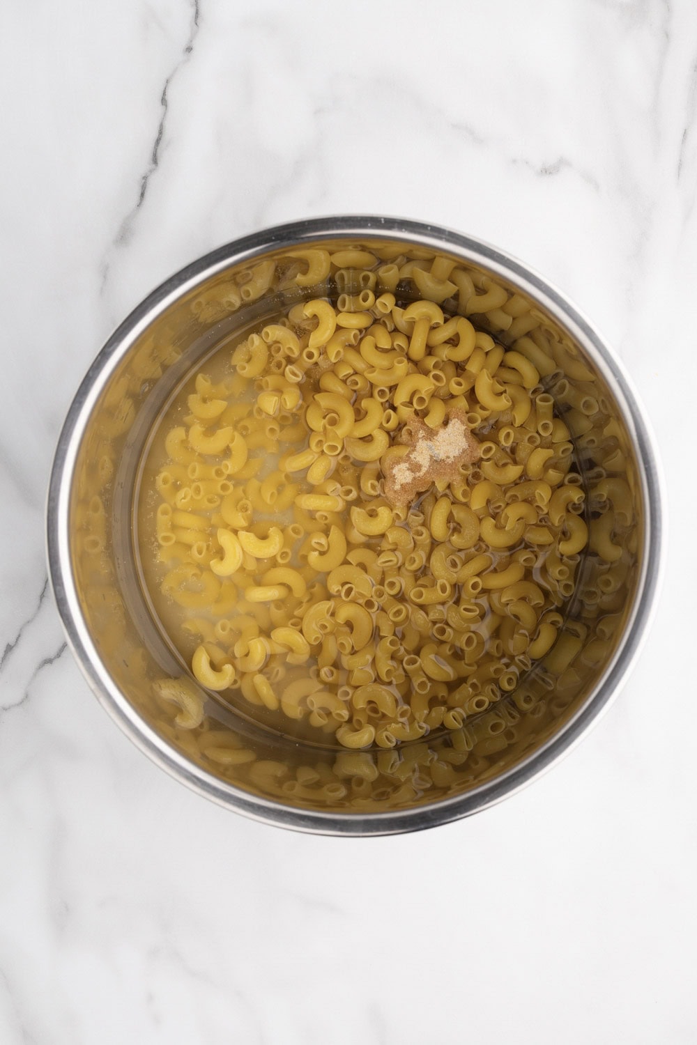 A bowl of macaroni and cheese in a metal pan