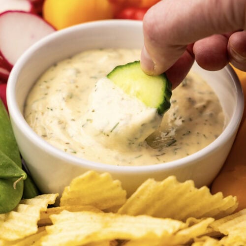 A platter of vegetables with dip and a bowl of chips