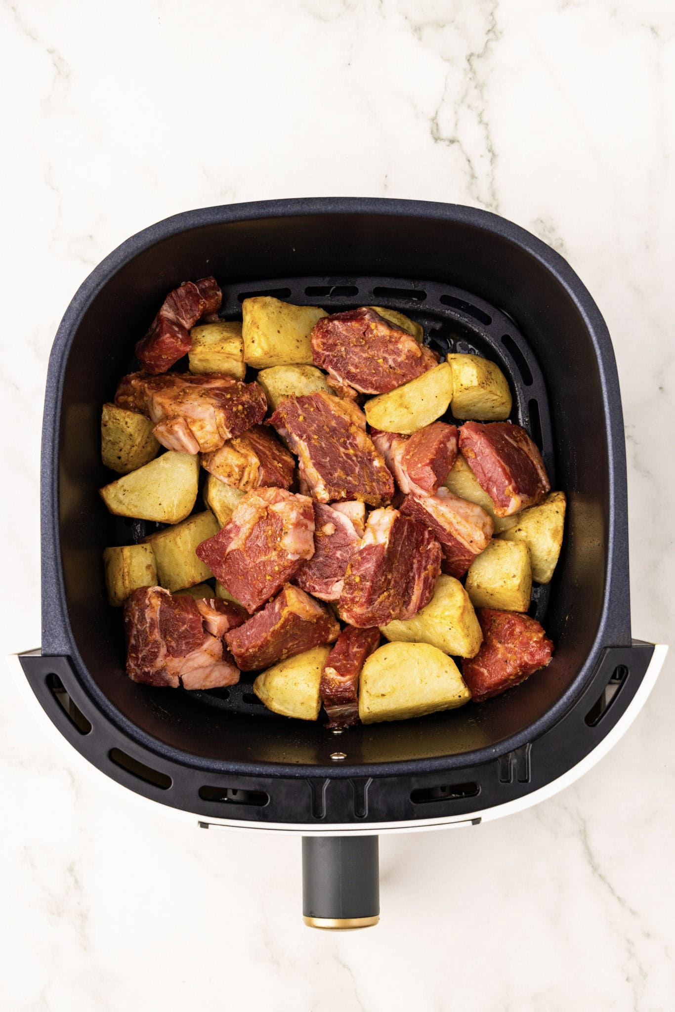 overhead shot of potatoes and uncooked steak
