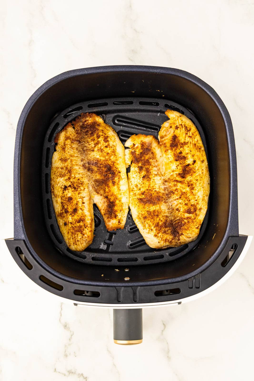 4 seasoned and air fried tilapia filet in air fryer
