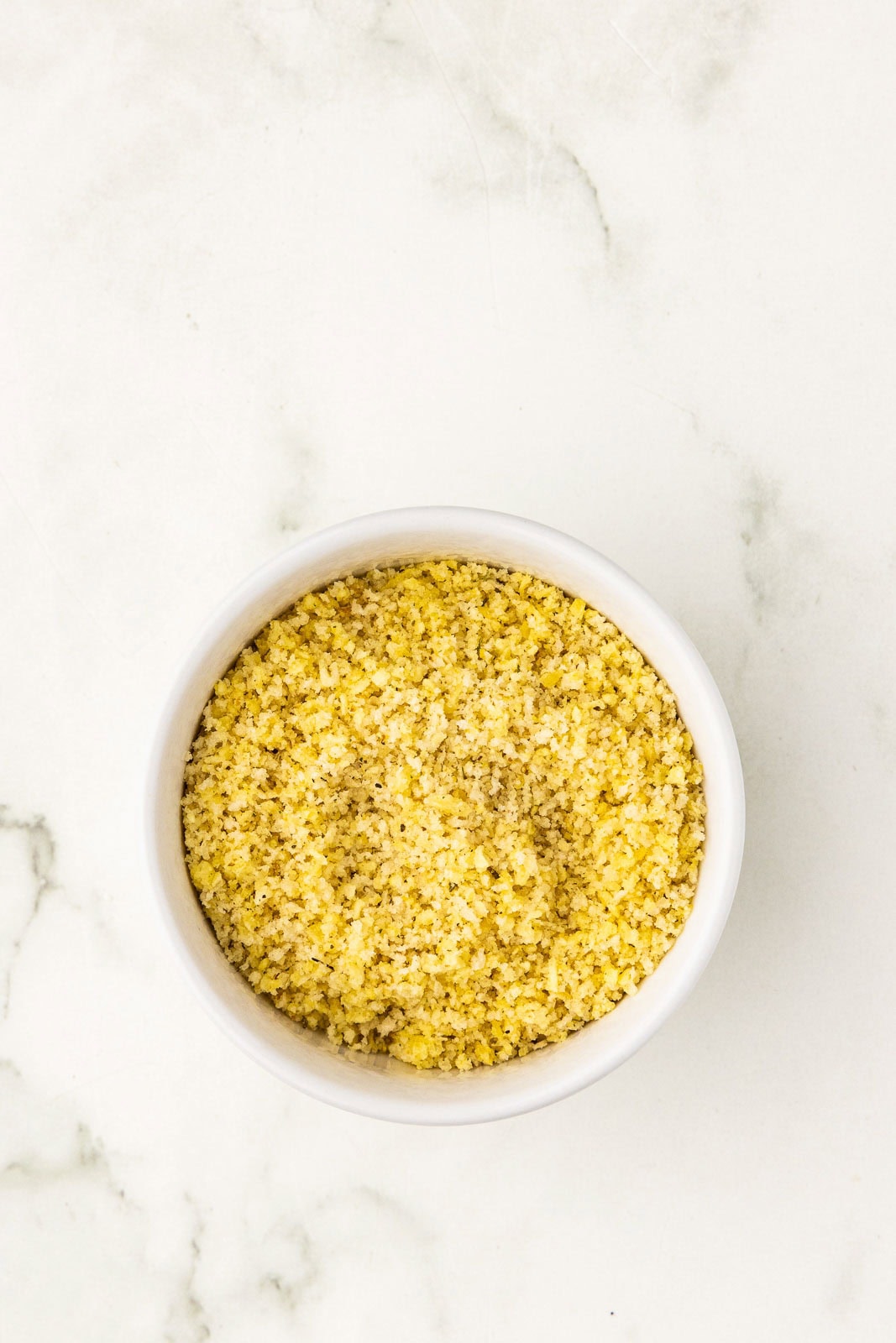 small white bowl of chips, panko and seasoning