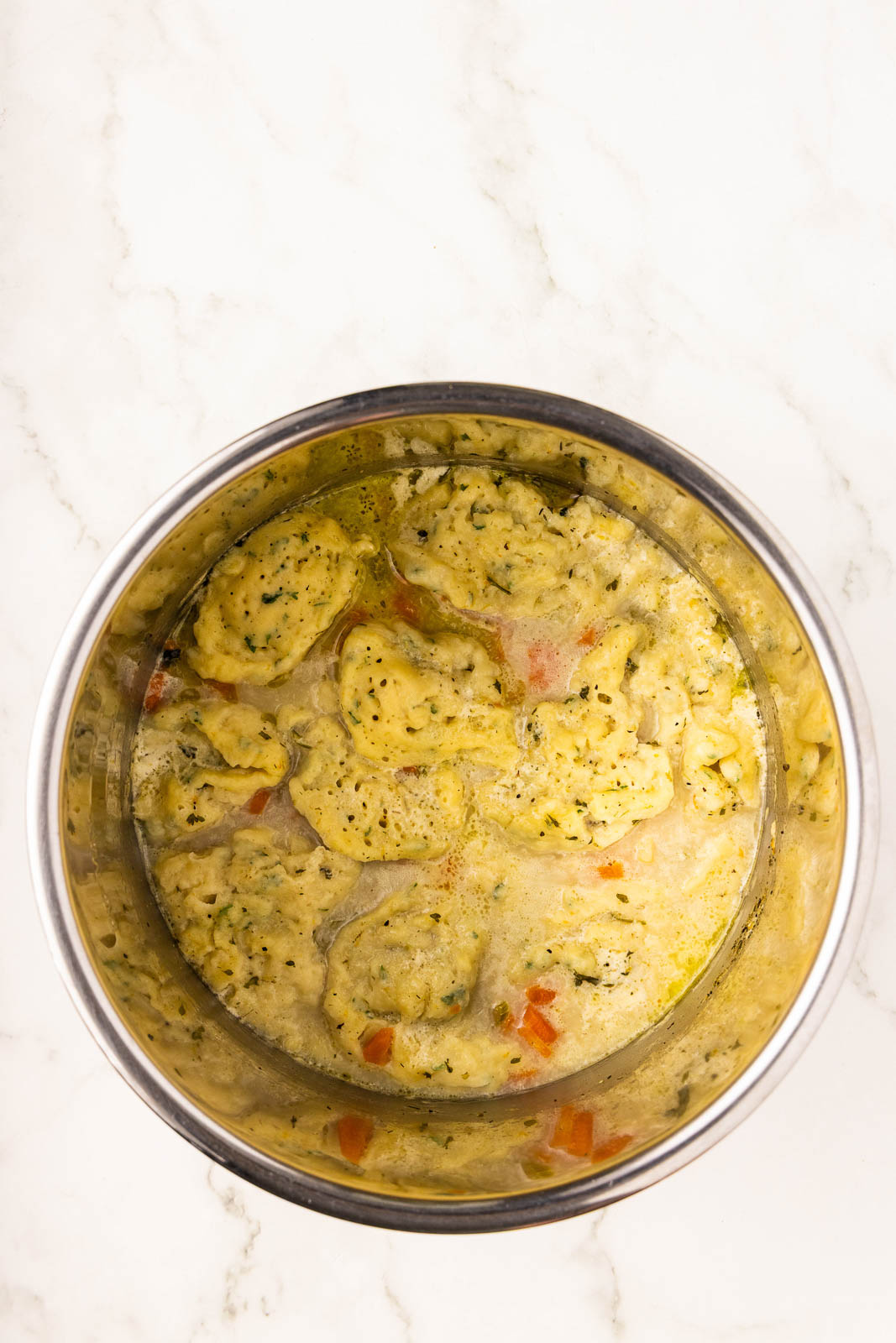 overhead view of instant pot with chicken and dumplings