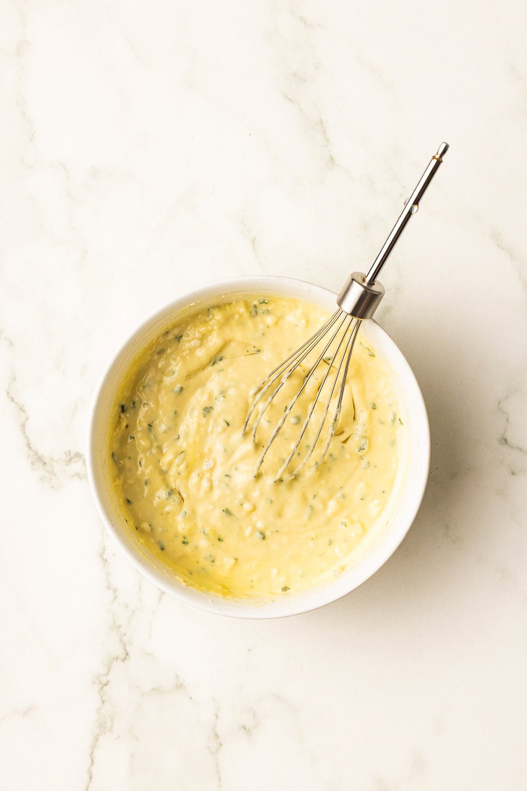 bowl of bread mixture with silver whisk